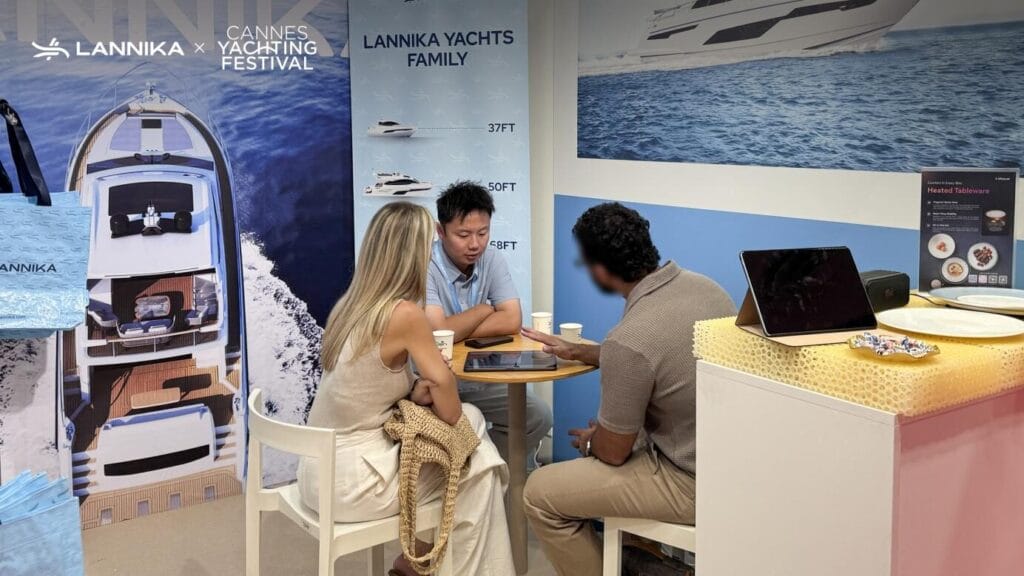 Lannika staff talk with clients at Booth